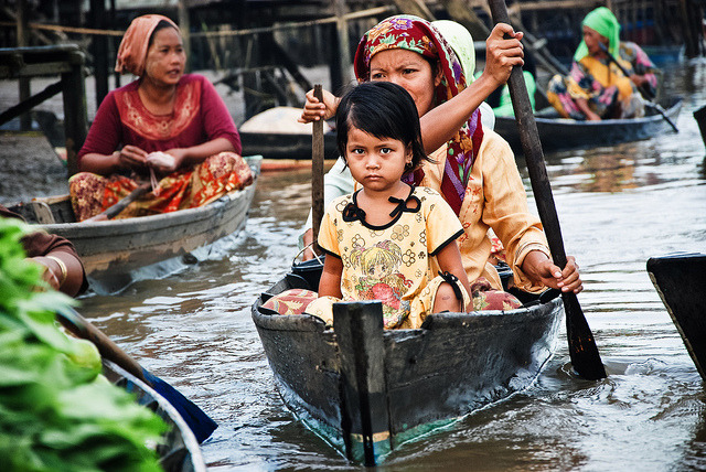 by volanthevist on Flickr.Young girl and her mother in a floating market, Kalimantan, Indonesia.