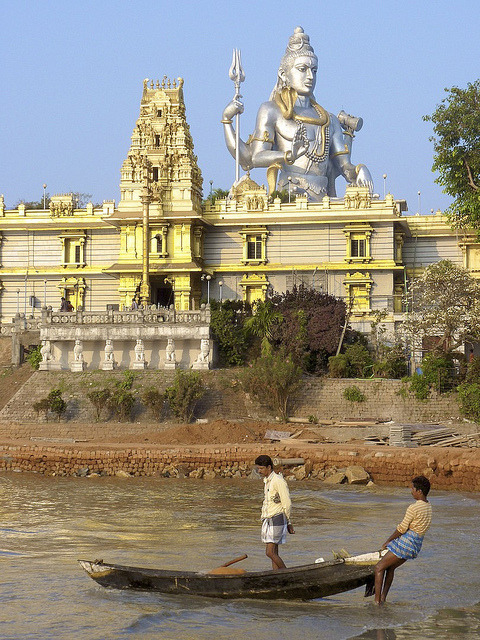 Fishermen taking out under the watchful eye of Shiva in Murudeshwara, Karnataka, India 