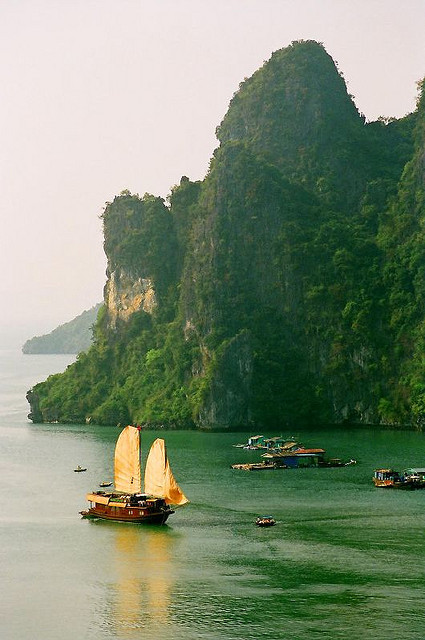 A junk with sails unfurled in Ha Long Bay, Vietnam