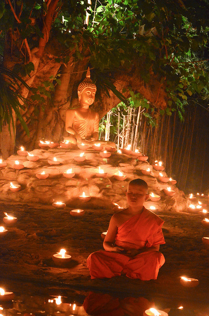 A novice monk meditating during a ceremony for Loi Krathong festival in Chiang Mai, Thailand